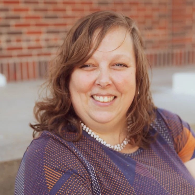 Andrea Bennett, smiling portrait, Director of Connections at OV Church, promoting community engagement and hospitality.