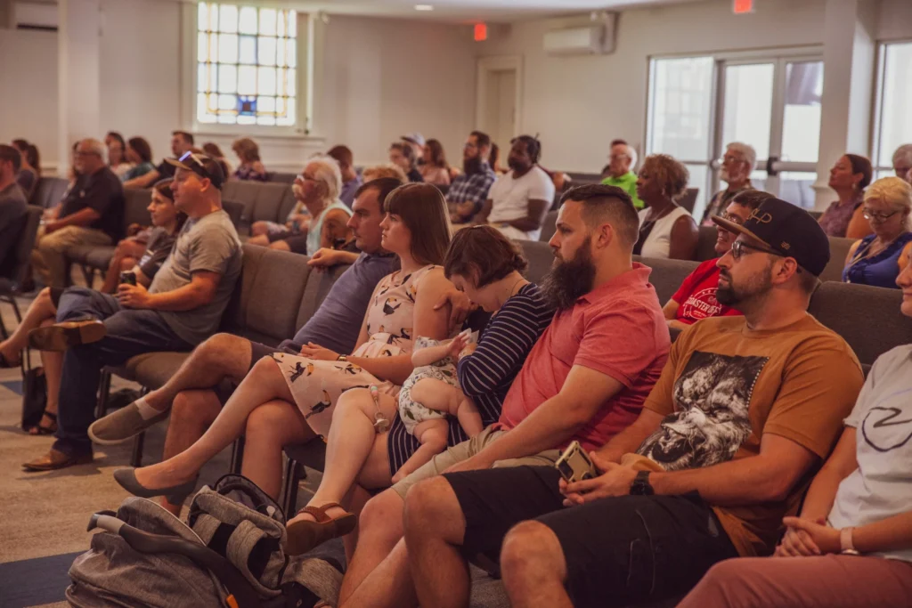 Diverse congregation seated in a church during a worship gathering, engaging in community worship and learning at Ocean View Church in Norfolk, Virginia.